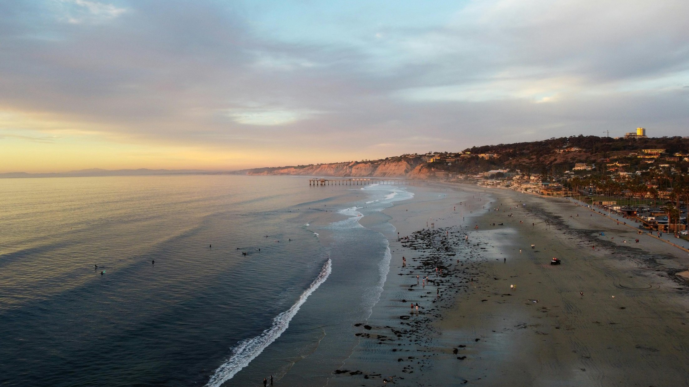 Aerial view of a coastline at sunset — the planet our green logistics protects