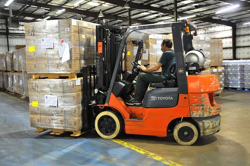 Forklift moving pallets in warehouse